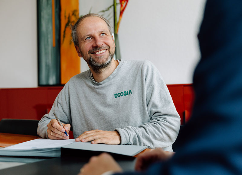 Ecosia CEO Christian Kroll signing the notarized declaration for the Climate Nobel Prize